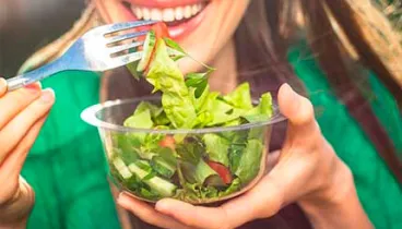 a woman eating a salad